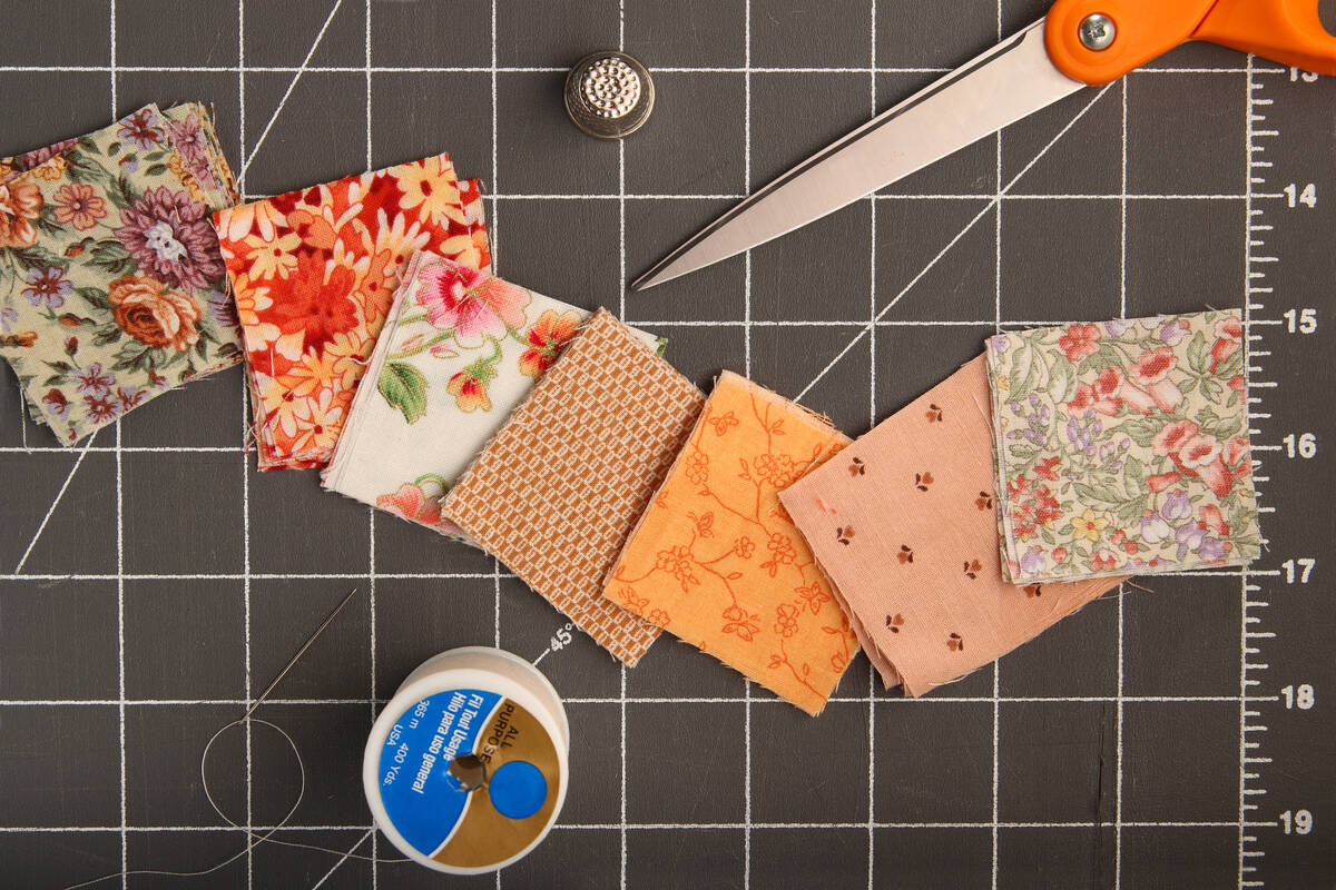 materiales y herramientas de patchwork en una plancha de corte